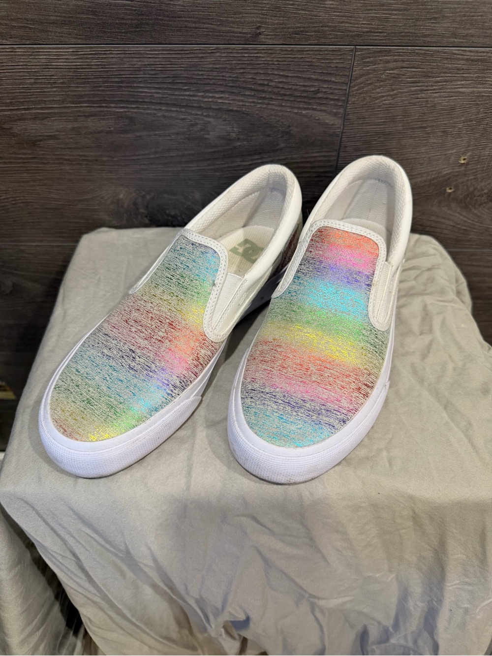 DC White Slip-On Sneakers with Iridescent Rainbow Uppers